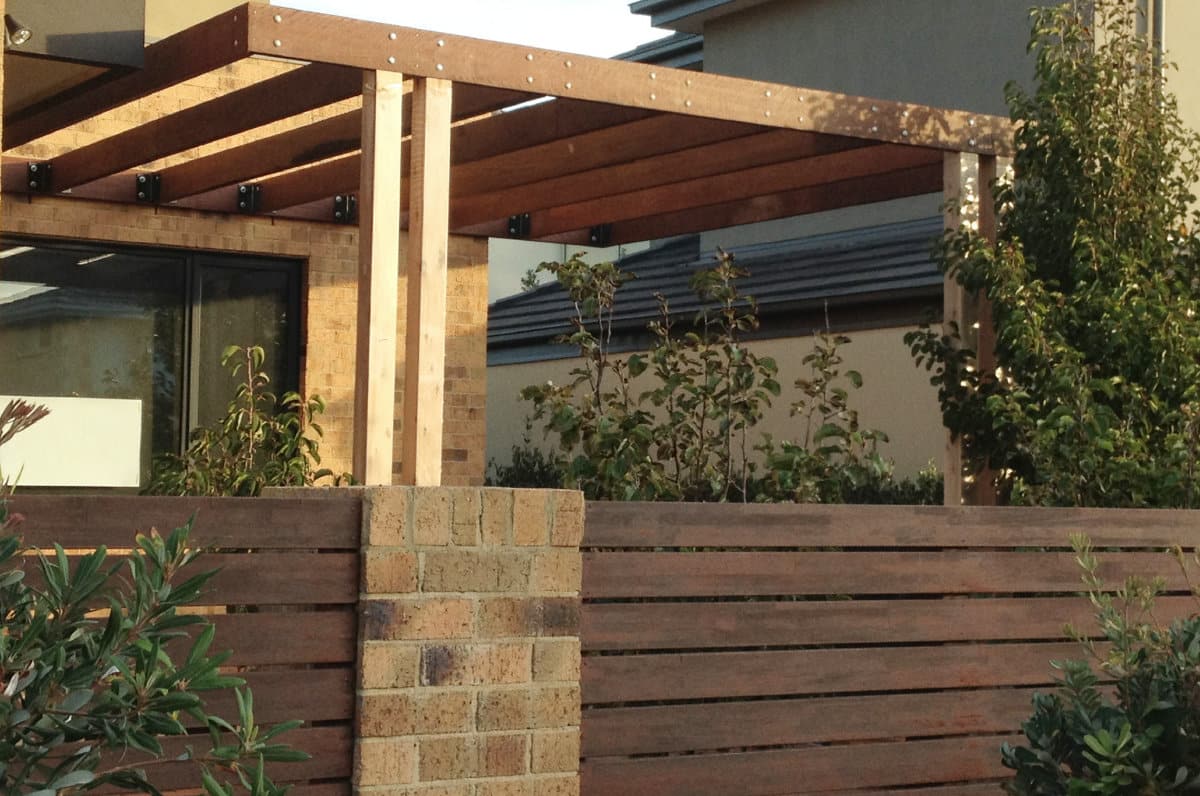 Wood and brick fence and wood pergola outdoor area Melbourne