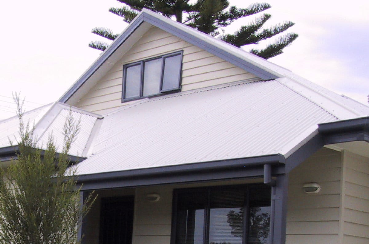 Steel coloured colour bond roofing with darker grey accents on cream coloured weatherboard house